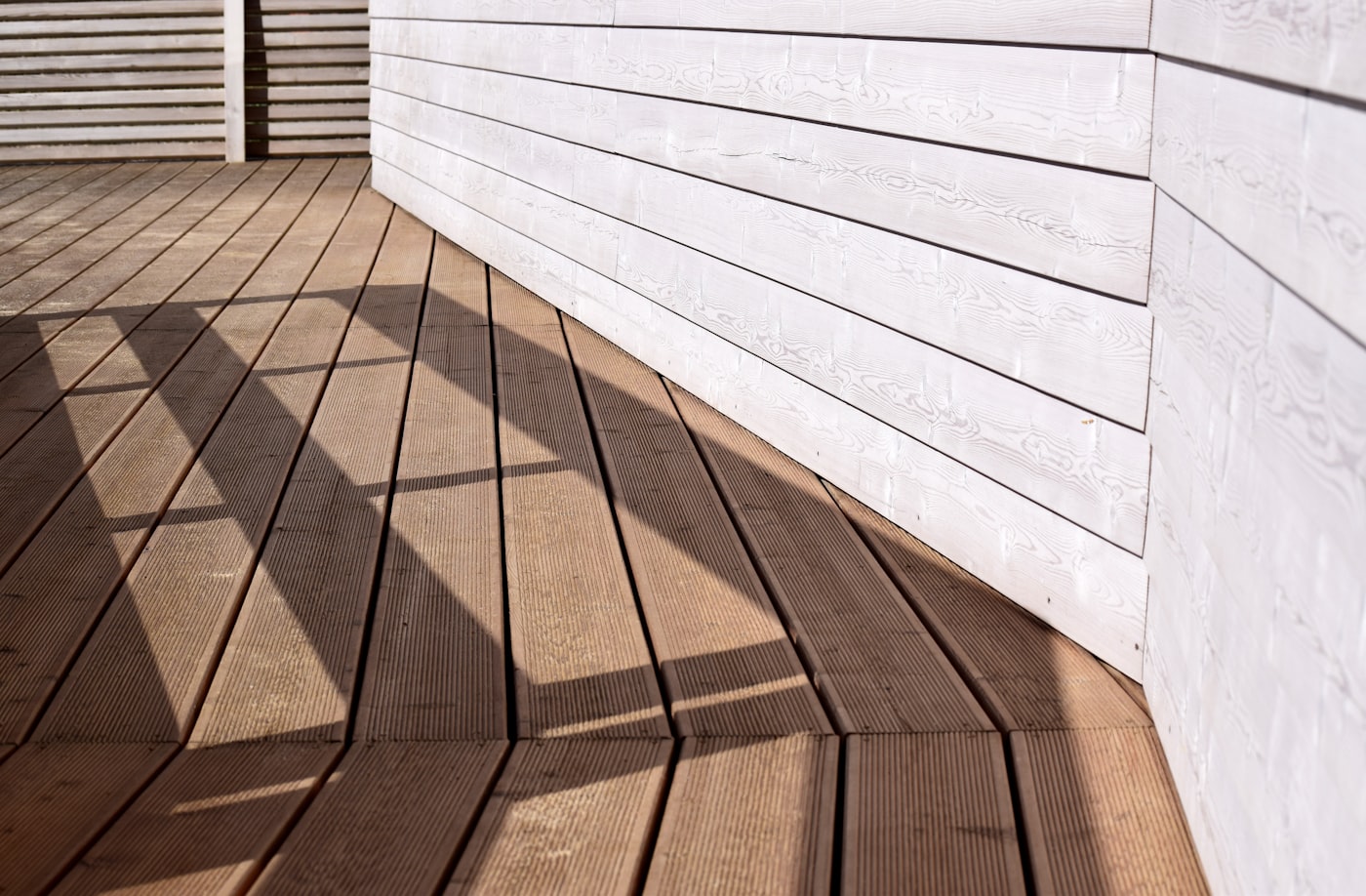 Composite deck with railings built onto the back of a suburban home