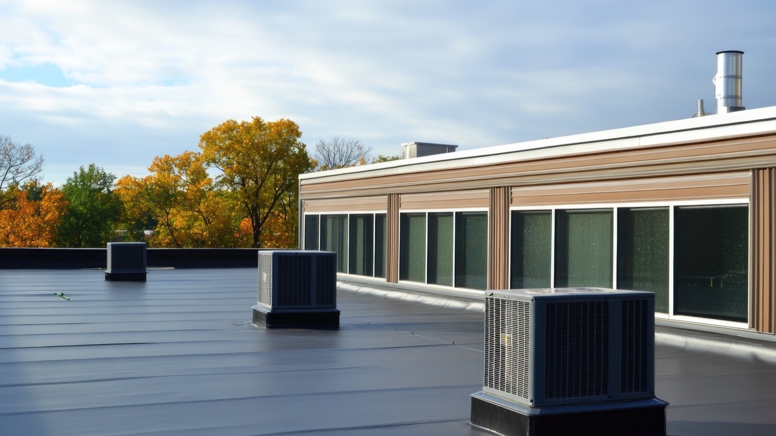 Flat and low-slope roofing on a Long Island building at dusk