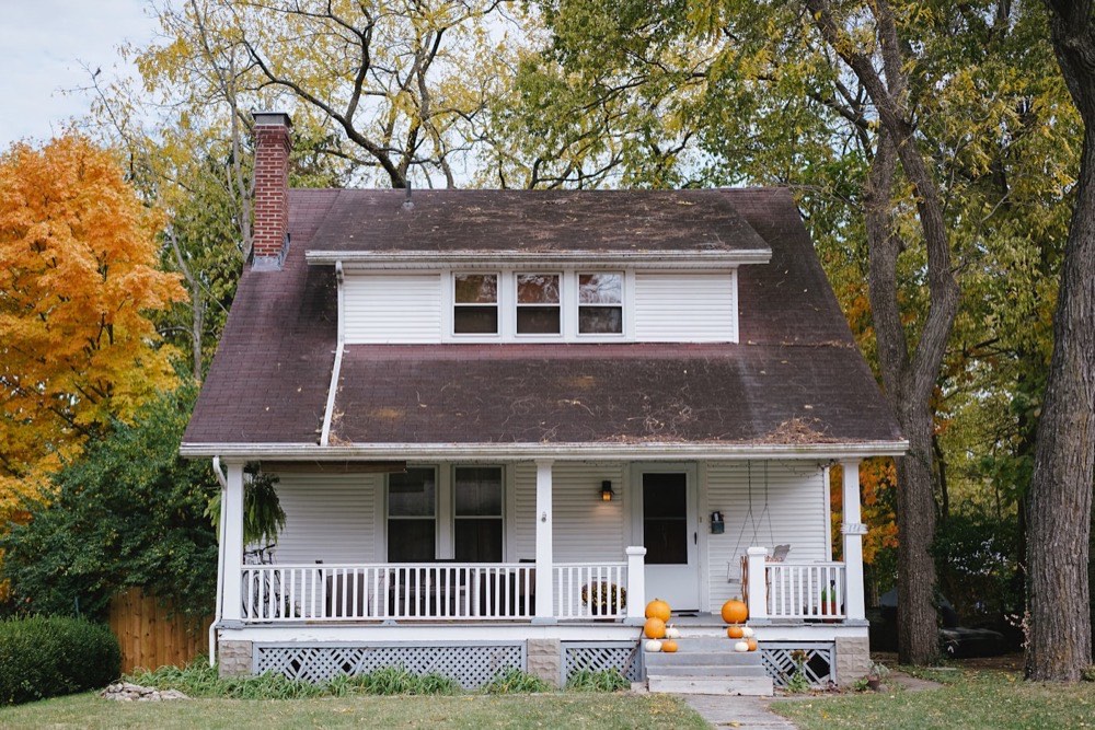Finished suburban home exterior with new roof, gutters and siding