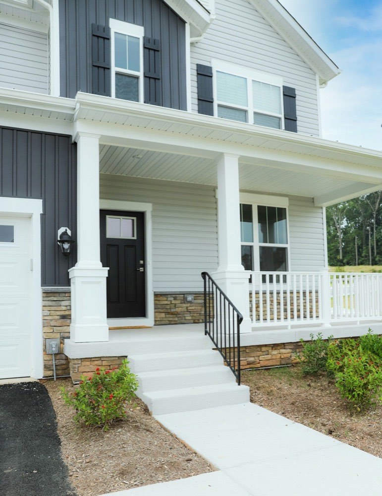 Crew installing vinyl siding with new house wrap on a Long Island home