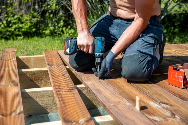 Deck boards and railing being repaired