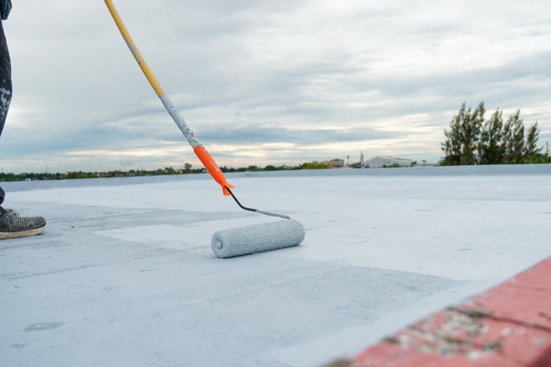 Silicone roof coating applied over an existing flat roof