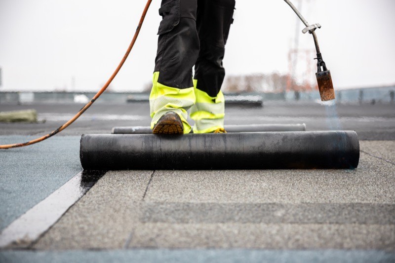 Torch-down modified bitumen roofing being installed