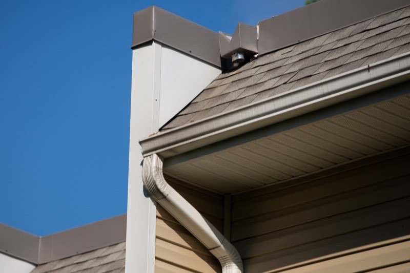 Damaged downspout being repaired