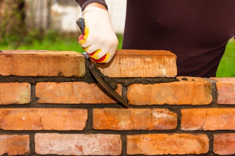 Damaged bricks being replaced in a wall