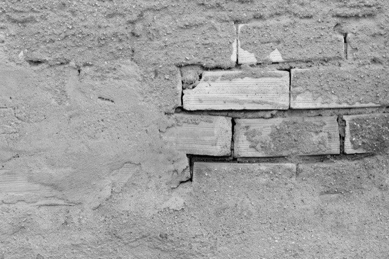 Mason repairing a brick wall