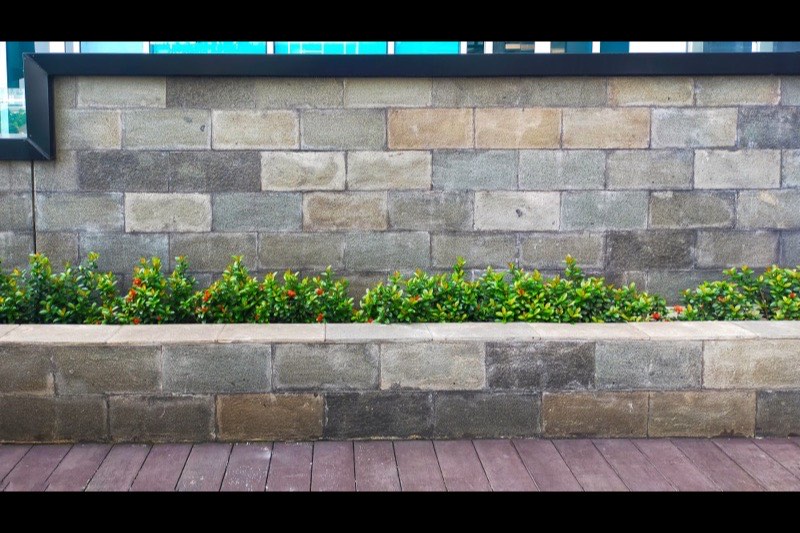 Stone retaining wall in a landscaped yard