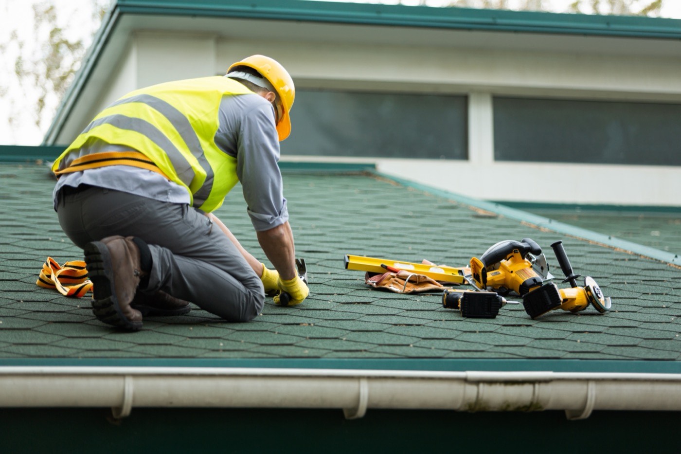 Cape Construction roofer securing underlayment before shingle installation